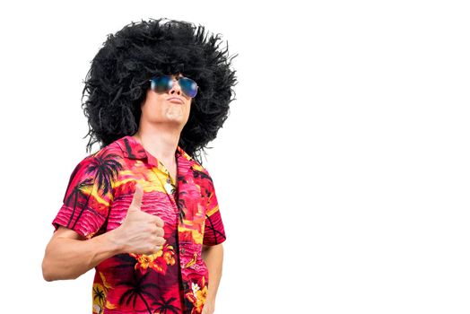Self assured man in trendy sunglasses and unusual Afro wig pouting lips and showing approving gesture against white background