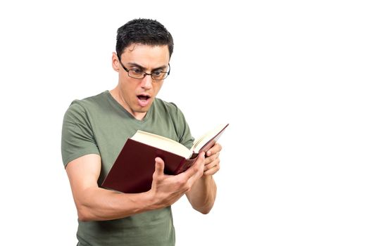 Astonished intelligent male in eyeglasses reading book and expressing amazement with opened mouth on white background