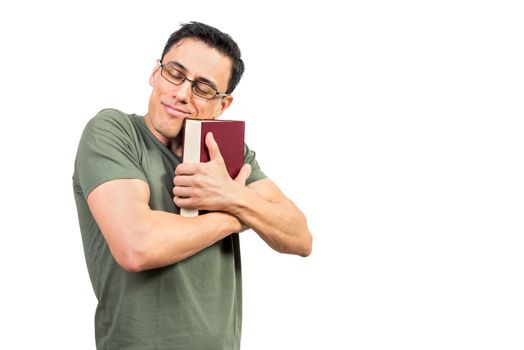 Peaceful smiling male bookwork in eyeglasses hugging volume of book against white isolated background