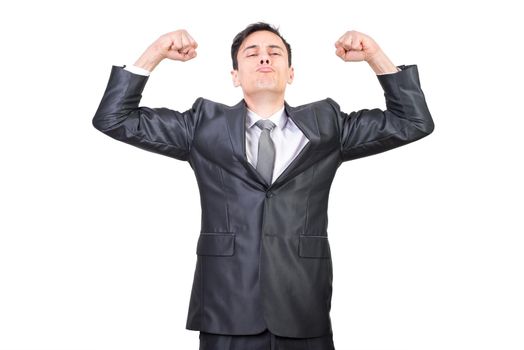 Confident male in formal suit pouting lips and clenching fists for showing power and strength against white background