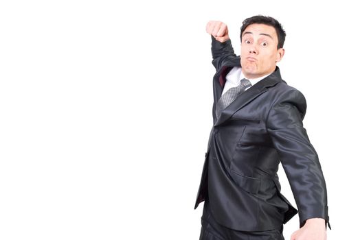 Aggressive young male entrepreneur in formal outfit with dark hair getting ready to hit with fist while standing against white background