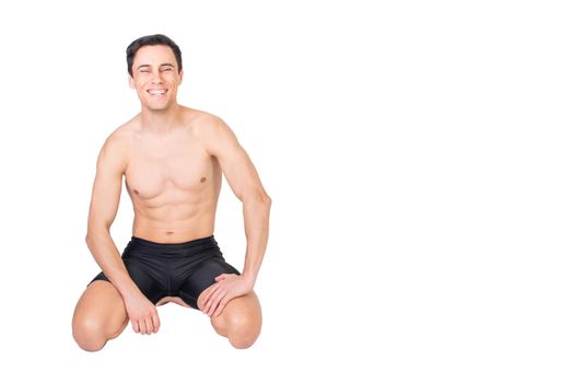 Full body of happy muscular male with naked torso looking at camera with smile during workout isolated on white background