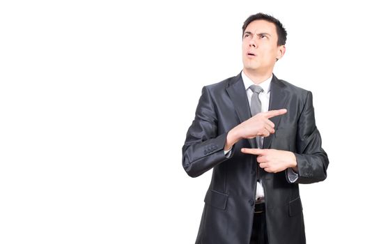 Confused young male manager in elegant suit with dark hair gesturing with fingers and looking away while counting in mind against white background