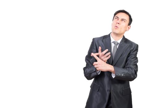 Thoughtful male in formal suit looking up and counting on fingers while standing isolated on white background in light studio