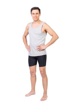 Full body of content barefoot male in activewear looking at camera with hands on waist isolated on white background in studio