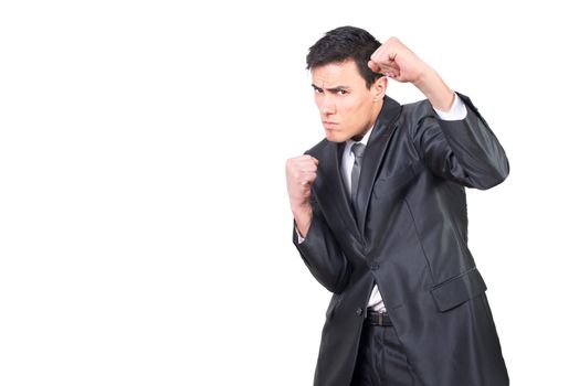 Frowning male in formal suit clenching fists for boxing kick in studio against white background