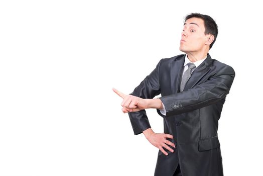 Handsome confident businessman in formal outfit pointing forward and scolding while standing on white background