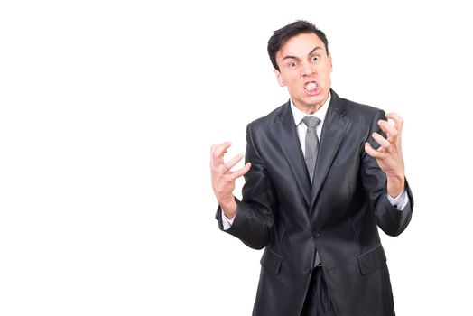 Furious and angry male in formal suit clenching teeth in rage and looking at camera with eyes wide open against white background