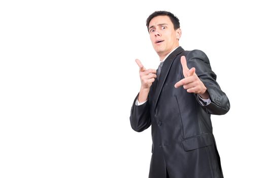 Mid shot of man in formal suit pointing at looking at camera with mad face expression isolated on white background in studio