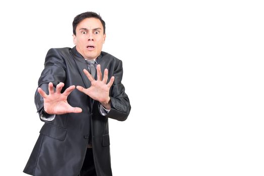 Scared young male manager in suit showing no gesture and looking at camera with horror on face against white background in studio