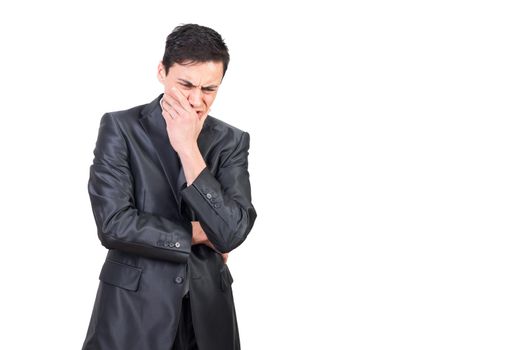 Exhausted worried man in formal suit expressing anxiousness touching face with hand while thinking over problem