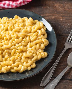 Delicious Mac n Cheese or macaroni and cheese on a black porcelain plate