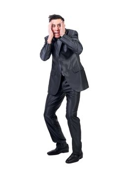 Full body of scared man in elegant suit looking away with hands on face isolated on white background in studio