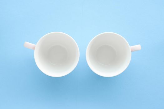 Kitchen, dishware and drinks concept - Empty cup and saucer on blue background, flatlay