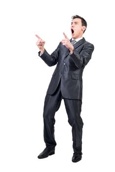 Full body of successful male in formal suit screaming with excitement and pointing up isolated on white background in studio