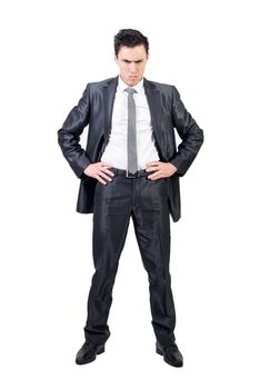 Full body of confident male in formal suit looking at camera with serious face and hands on waist isolated on white background