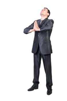 Full length of peaceful male entrepreneur in suit doing yoga with Namaste hands while meditating and relieving stress against white background