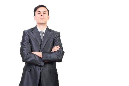 Serious confident male manager in formal suit standing with crossed arms against white background while looking at camera