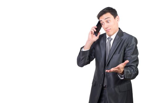Mid shot of perplexed male entrepreneur in formal wear having phone conversation while standing isolated on white background in studio