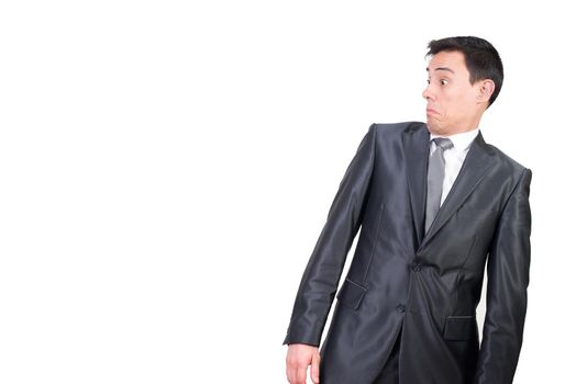 Mid shot of shocked male entrepreneur in elegant suit looking aside with astonished face expression isolated on white background in studio