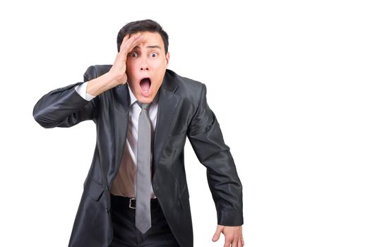 Astonished male entrepreneur in formal outfit touching face and looking at camera while standing isolated on white background in studio