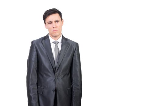 Mid shot of upset man informal wear looking at camera with disappointment face while standing isolated on white background in studio