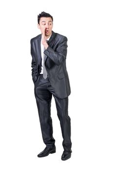 Full length of male entrepreneur in suit spreading rumors on white isolated background in studio