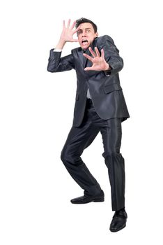 Full body of afraid male in formal suit with outstretched arm looking at camera isolated on white background in studio