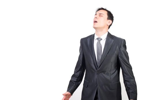 Handsome concentrated man in formal suit relaxing and enjoying pleasure state standing against white background with closed eyes