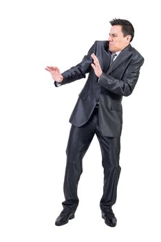 Full body of unpleasant male with disgusted face in elegant suit standing isolated on white background in modern light studio