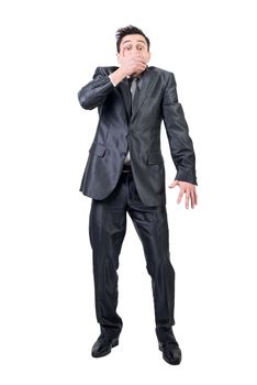 Full body of male loudmouth in formal suit looking at camera while covering mouth isolated on white background in studio