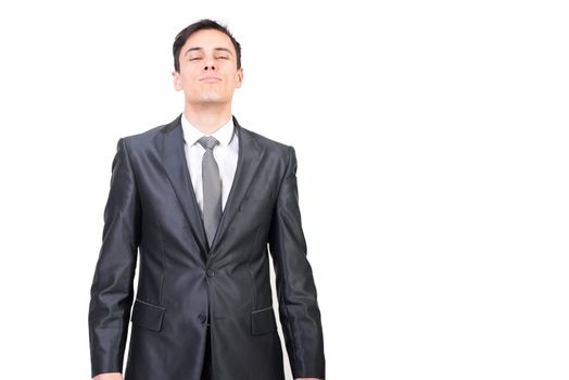 Confident handsome male entrepreneur in classy outfit with tie standing with closed eyes against white background