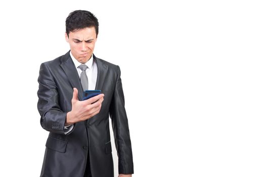 Concerned male reading bad news in message on mobile phone and expressing anxiety and concern