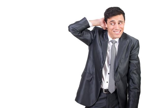 Mid shot of timid male entrepreneur in elegant suit looking aside with hand behind head while standing isolated on white background