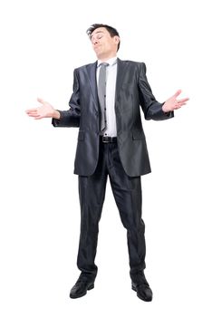 Full body of self assured male in formal suit standing with closed eyes isolated on white background in light studio