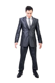 Full body of confident male in formal suit frowning and looking at camera isolated on white background in light studio