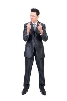 Full body of content rich male in formal suit looking at camera with money gesture isolated on white background in studio