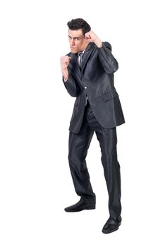 Confident male entrepreneur in classy suit standing with clenched fists and pretending being boxer while looking at camera on white background