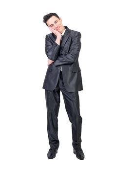 Full body of enamored man in formal suit looking away with dreamy face expression isolated on white background in studio