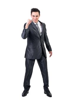 Full body of confident male in formal suit looking at camera with smile and clenched fist while celebrating victory isolated on white background in studio