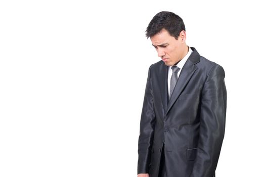 Mid shot of discontent male entrepreneur in formal wear looking down with frustration while standing isolated on white background in studio