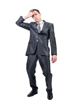 Full body of exhausted male in formal suit wiping sweat from forehead and looking at camera isolated on white background