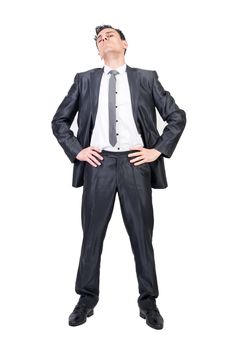 Full body of serious male in classy suit looking at camera with hands on waist isolated on white background in studio