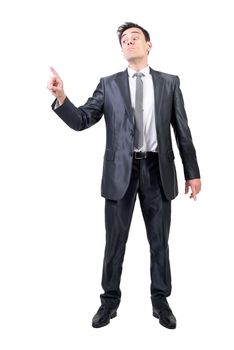 Full body of focused male in formal suit looking at pointing finger while standing isolated on white background in studio