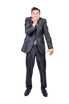 Funny anxious male entrepreneur in formal suit biting nails and looking at camera on white background