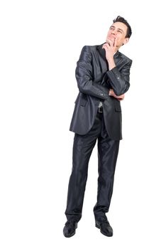 Full length of content pensive male entrepreneur in suit touching chin and looking up on white isolated background