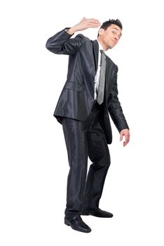 Full body of male boss in formal suit gesticulating with hand and inviting to come in studio against white background