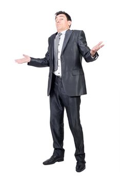 Full body of hesitant male in suit spreading arms and shrugging shoulders in bewilderment in studio against white background