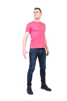 Full length confident male in casual clothes looking away with serious face while being hero against white background