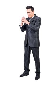 Full body of cunning male entrepreneur in formal suit having evil plans while looking at camera against white isolated background